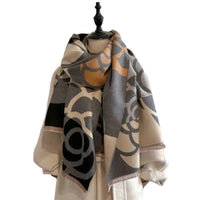 Patterned scarf draped over a mannequin against a plain background