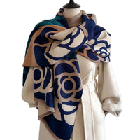 Mannequin wearing a patterned scarf with a plain background