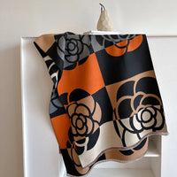 Patterned fabric draped over a white frame against a plain background
