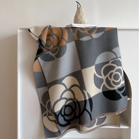 Floral patterned blanket draped over a white cabinet.