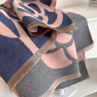 Folded fabric with geometric pattern on a white surface
