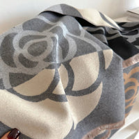 Close-up of a patterned scarf with geometric design on a neutral background