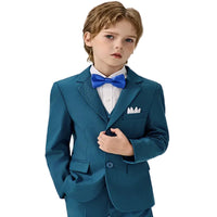 Young boy wearing a teal suit with a blue bow tie on a white background