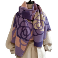 Mannequin wearing a purple floral patterned scarf against a plain background