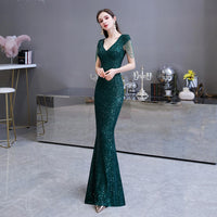 A Woman with a Dark Green Sequin Prom Party Dress