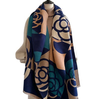 Mannequin wearing a patterned scarf with blue and beige design on a plain background