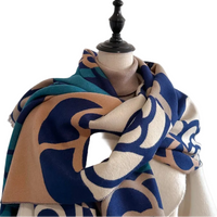 Patterned scarf draped over a mannequin against a plain background