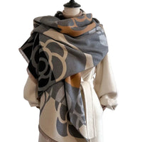 Mannequin wearing a patterned scarf with a plain background